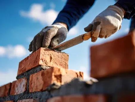Mason rebuilding the top of a brick chimney in Sunnyvale